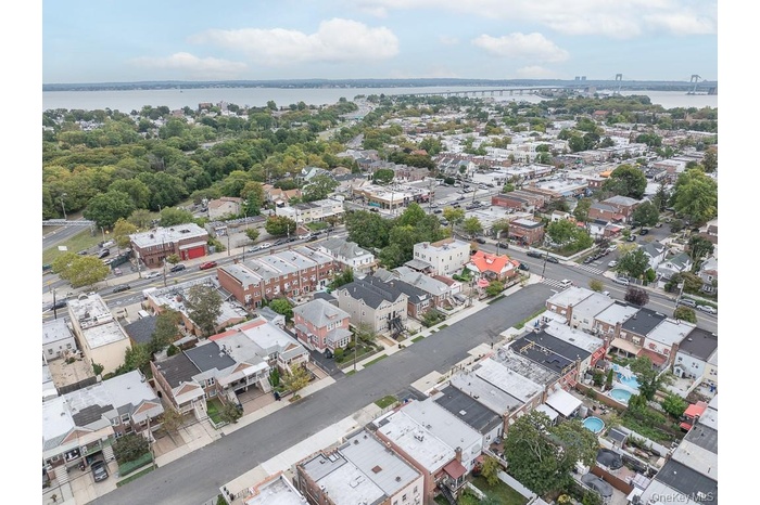 Aerial view of property and surrounding area with a large body of water