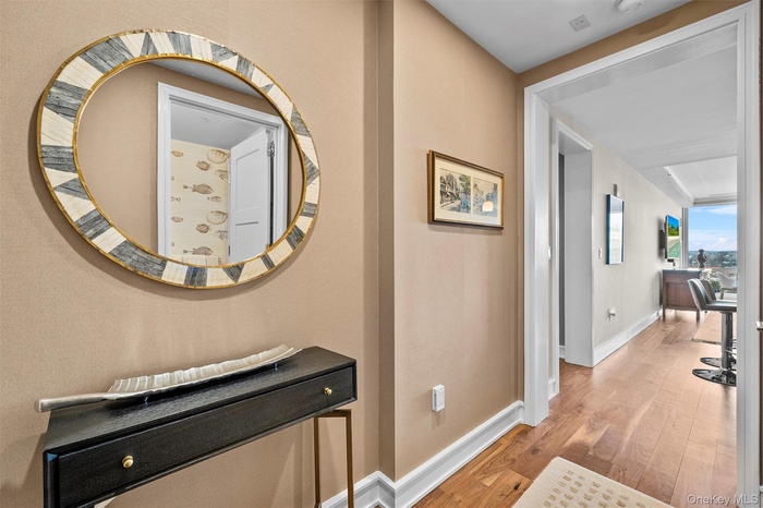 Hallway with wood finished floors and baseboards