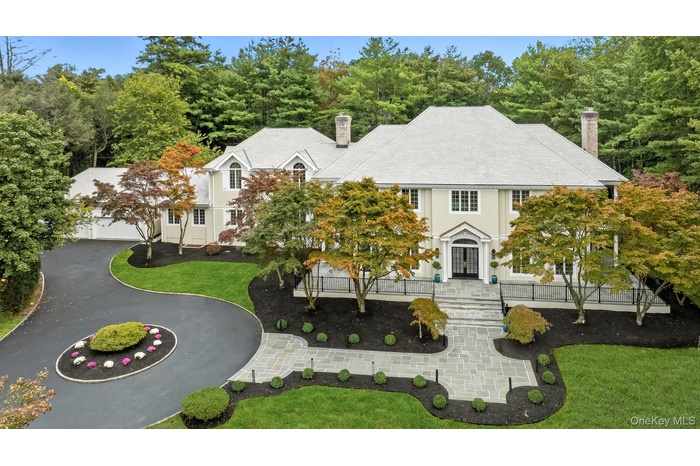 Mediterranean-inspired Colonial on 1.22 acres of gorgeous level park-like property in Scarsdale's prestigious Murray Hill Estate area