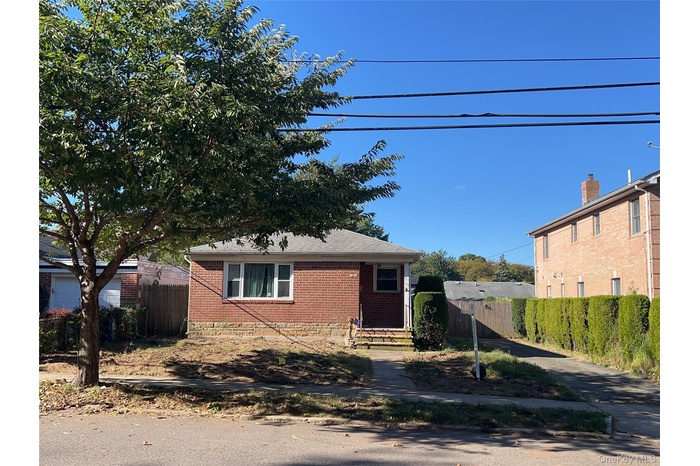 View of front of home featuring brick siding and a shingled roof