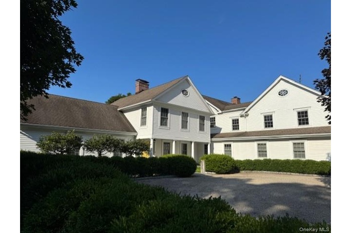 View of front facade featuring a chimney