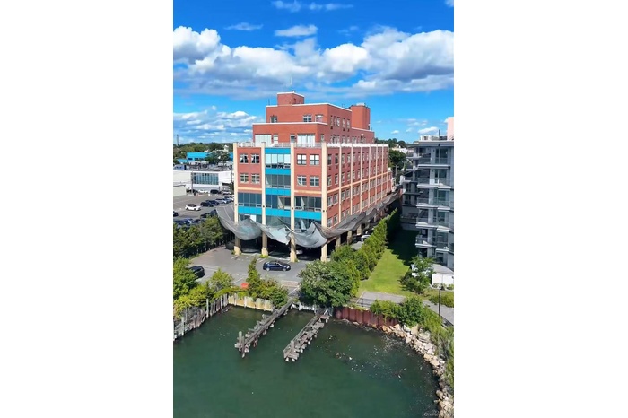 View of apartment building / complex featuring a water view