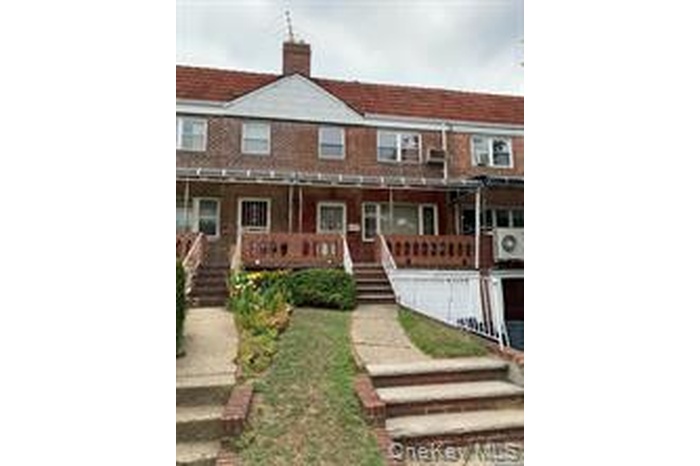 View of front of house featuring stairs, a chimney, and a porch