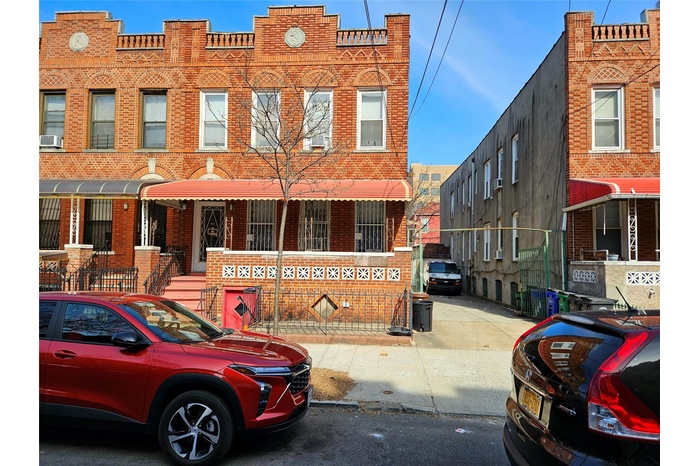 View of property with brick siding