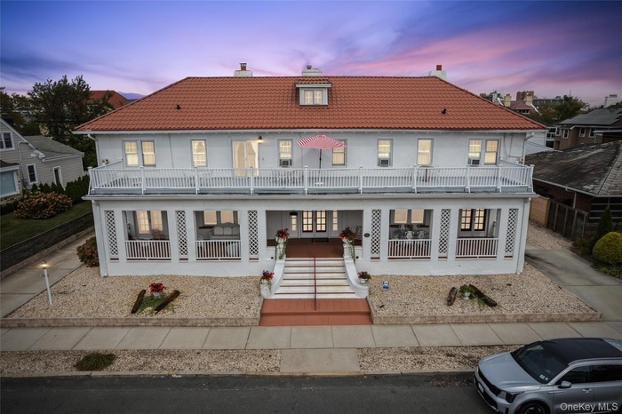 View of front of house featuring a chimney and a tiled roof