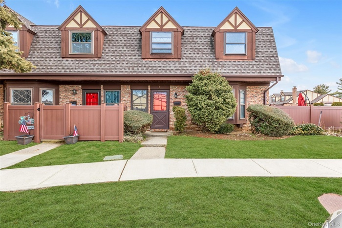 Tudor house with a shingled roof and brick siding