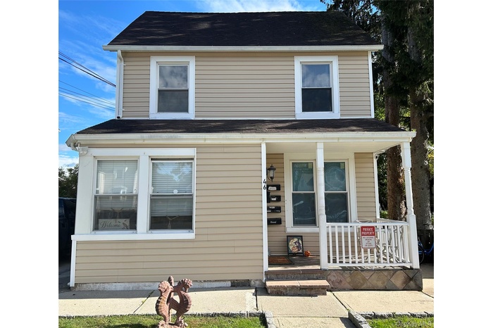 View of front of property featuring covered porch and roof with shingles