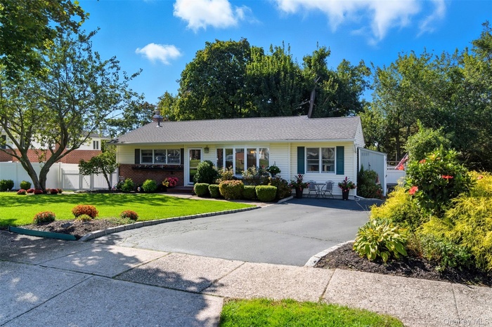 Ranch-style home with brick siding and concrete driveway