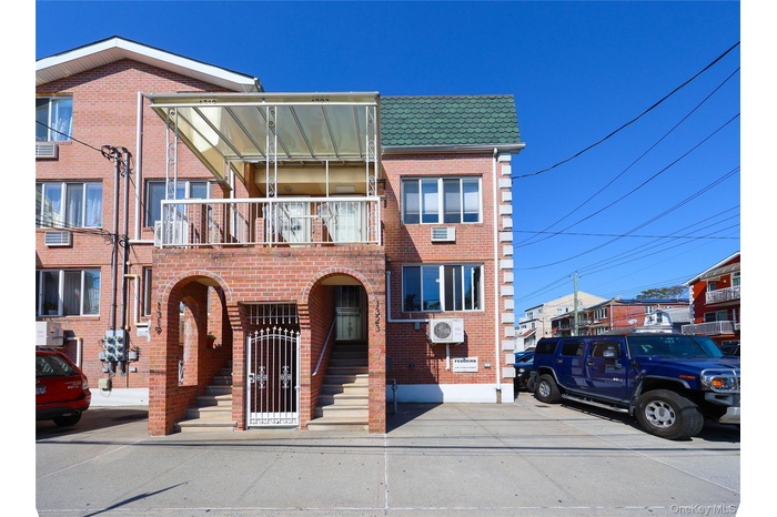 Traditional-style house featuring a balcony and brick siding