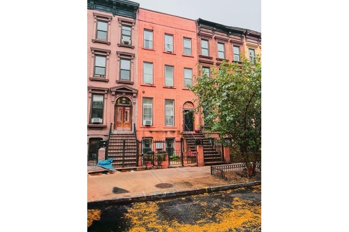 View of property featuring a fenced front yard