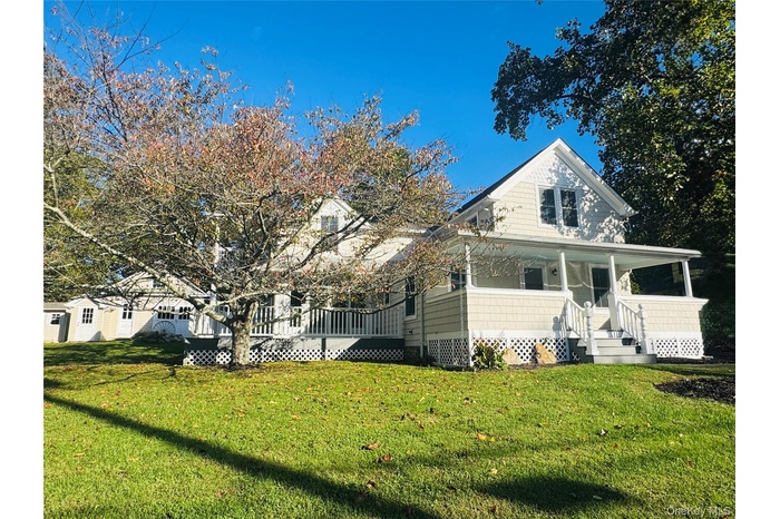 View of front of property with a front lawn and covered porch