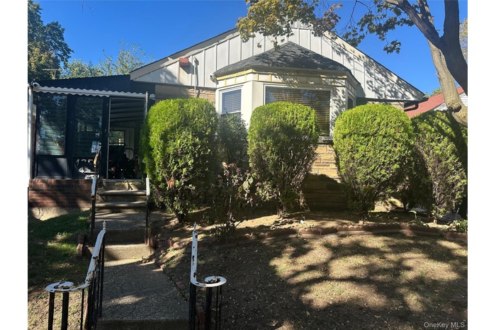 View of property exterior with a sunroom and board and batten siding
