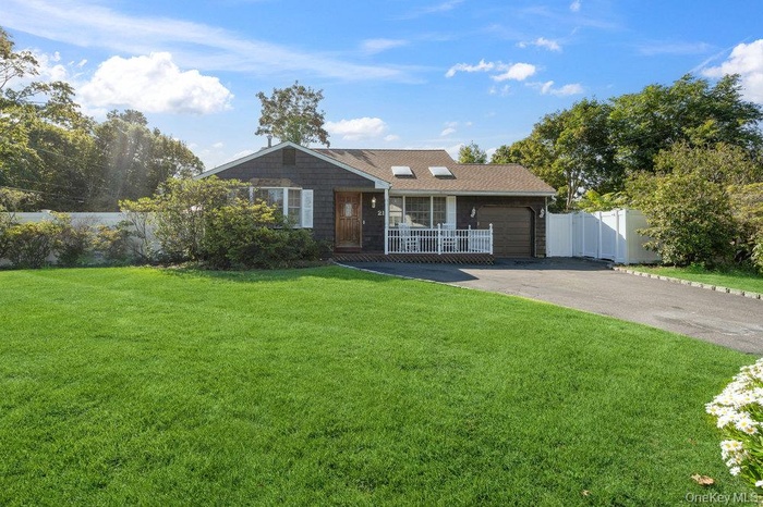 Ranch-style home featuring driveway and a garage