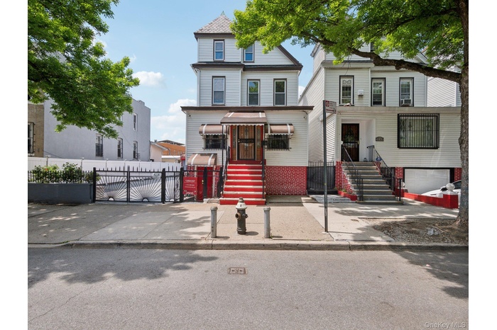 View of front of house featuring fence and a gate