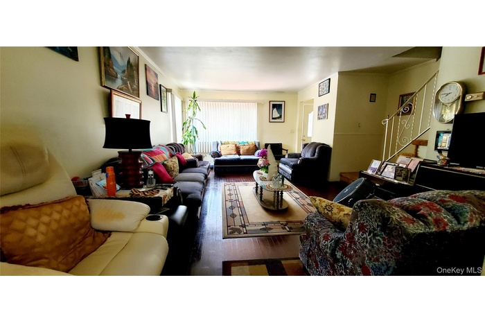 Living room with dark wood-type flooring