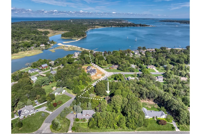 Aerial view of property and surrounding area featuring a large body of water