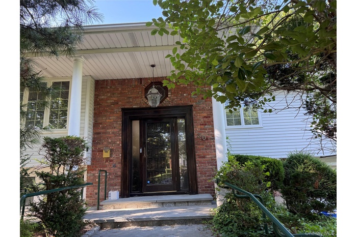 Entrance to property featuring brick siding
