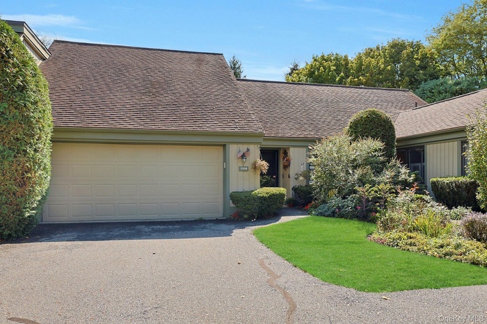 View of front of 593B, front yard, and 2 car garage