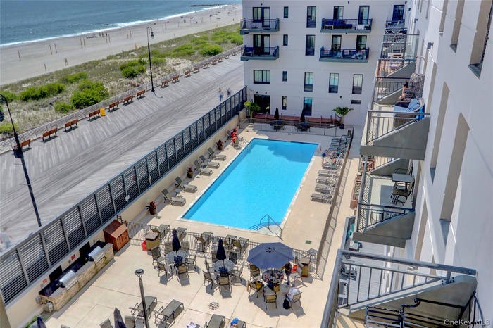 Community pool with view of water and beach