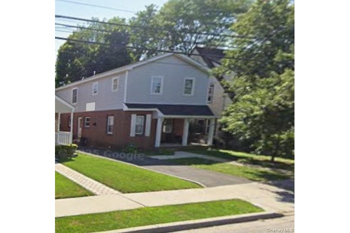 View of front of home featuring a porch and a front lawn