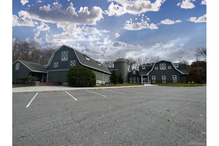 Uncovered parking lot with a barn