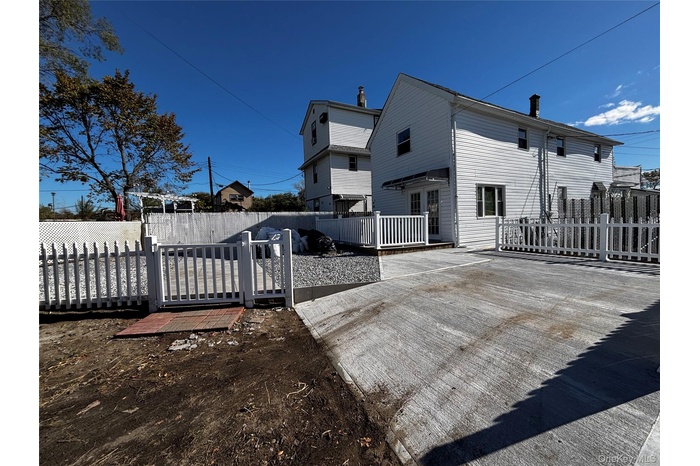 Rear view of house featuring a wooden deck