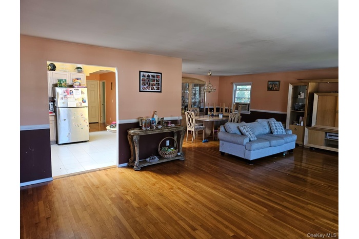 Living room with hardwood / wood-style flooring and arched walkways