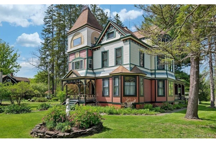 View of front of house with a front yard and a porch