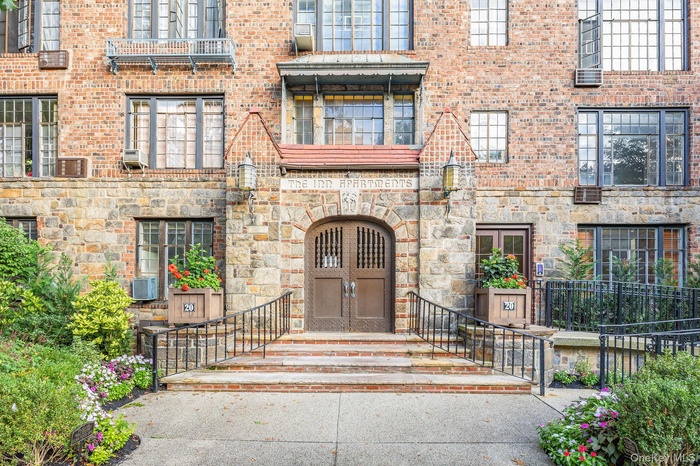 View of exterior entry featuring stone siding and brick siding