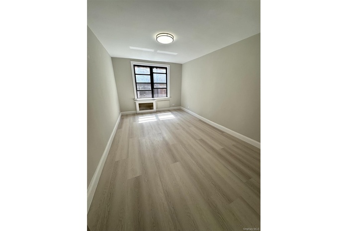 Spare room with light wood-type flooring and baseboards