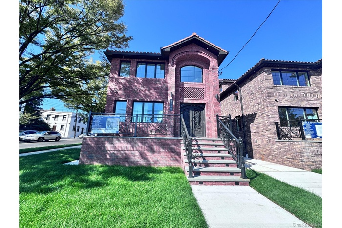 Mediterranean / spanish house with a front lawn and brick siding