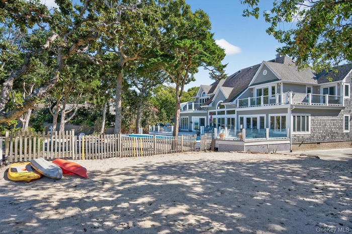 View of front of property featuring roof with shingles, crawl space, and a patio area
