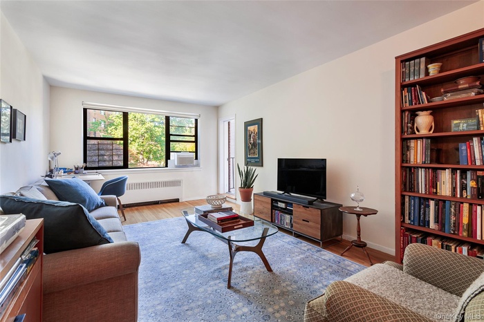 Living area with radiator and wood finished floors