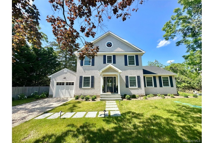 View of front of home with gravel driveway
