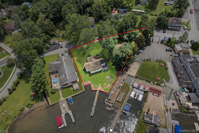 Aerial view of property's location featuring property parcel outlined and a large body of water