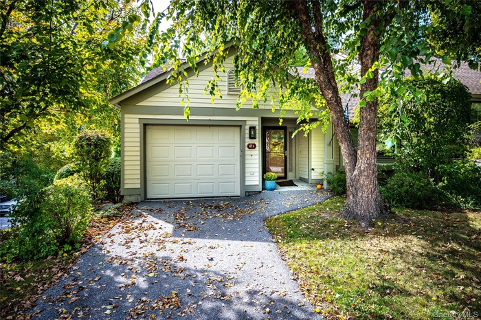 View of front of home with asphalt driveway