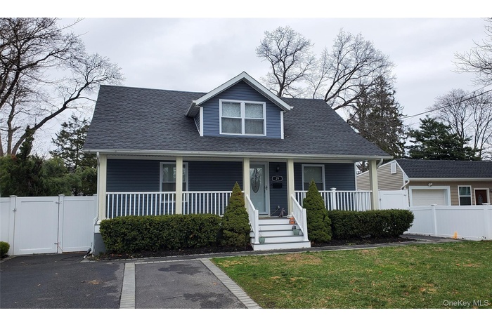 Bungalow-style house with a gate, covered porch, and roof with shingles