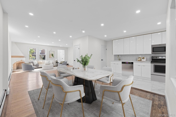 Dining space with recessed lighting, a baseboard radiator, and light wood finished floors