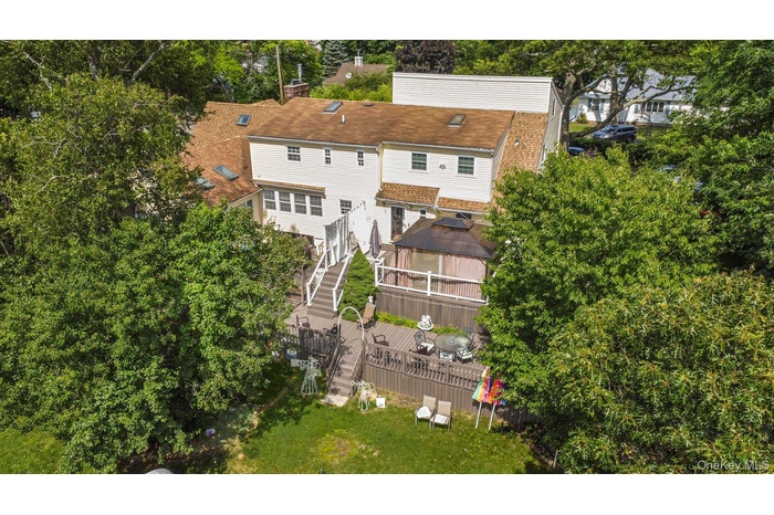View from above of property featuring a tree filled landscape