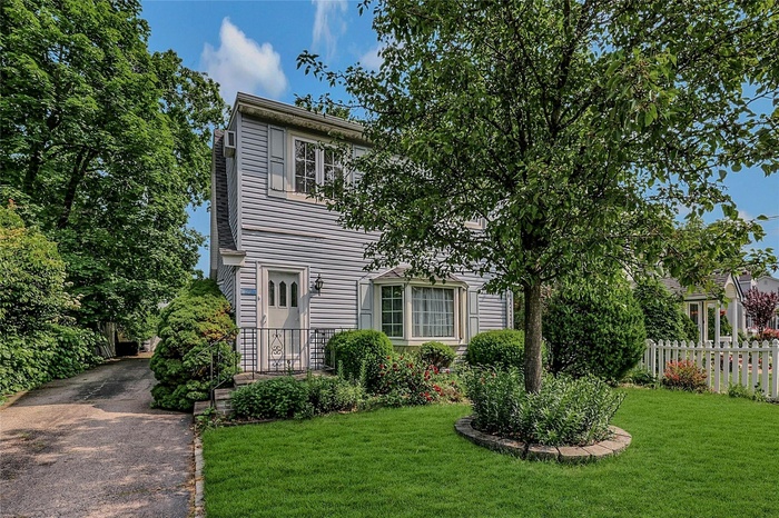 View of front of home with asphalt driveway