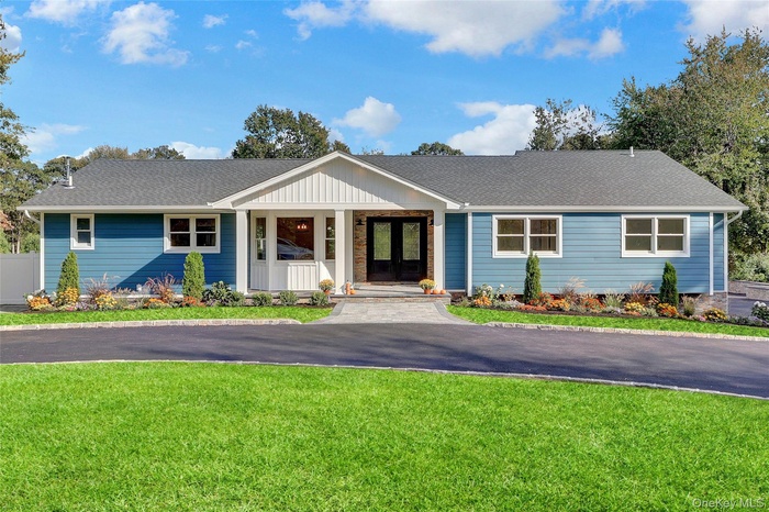 Ranch-style house featuring a front yard, roof with shingles, and covered porch