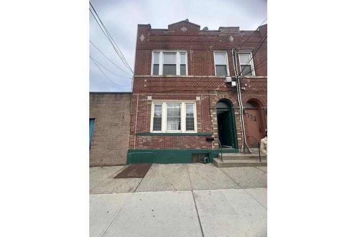 View of front of home featuring brick siding