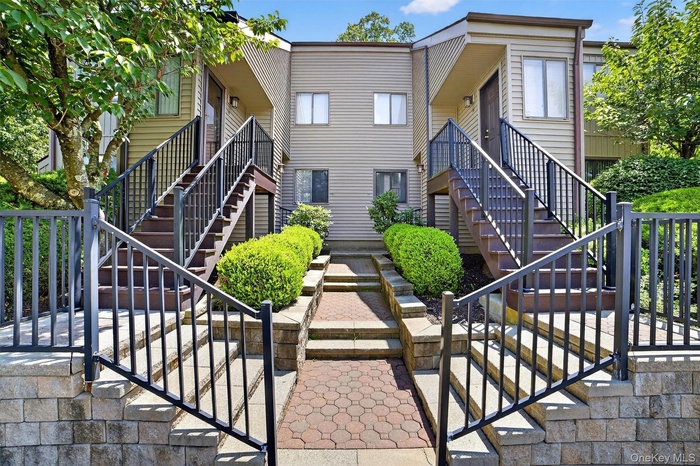 View of front facade featuring stairway