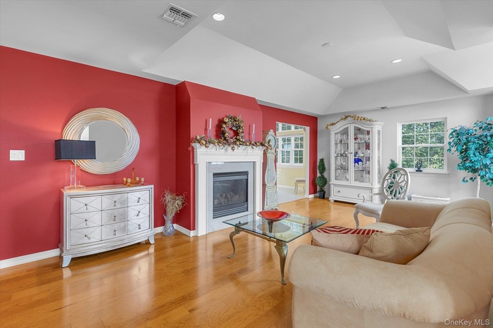 Living room with fireplace, Brazilian wood floors and vauted ceiling
