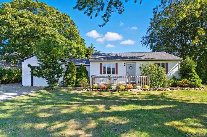 Single story home with a front lawn and a garage