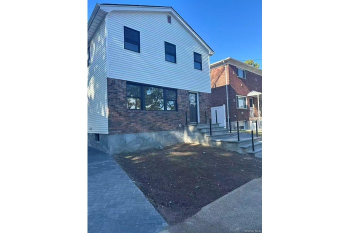 View of front of property with brick siding