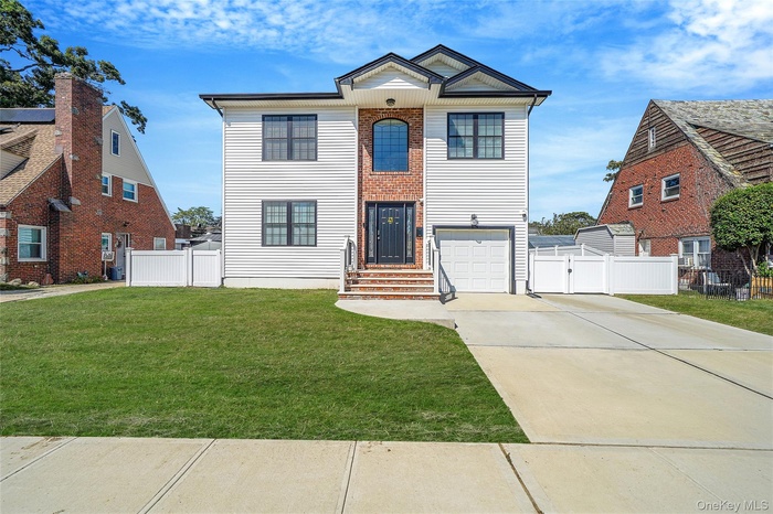 View of front of home featuring driveway and a garage