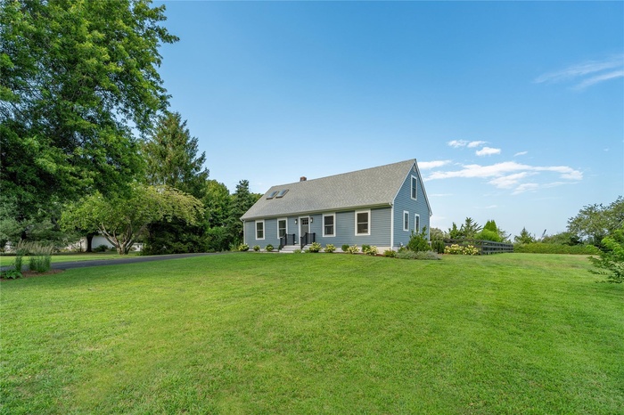 View of front of home with a front yard and a chimney