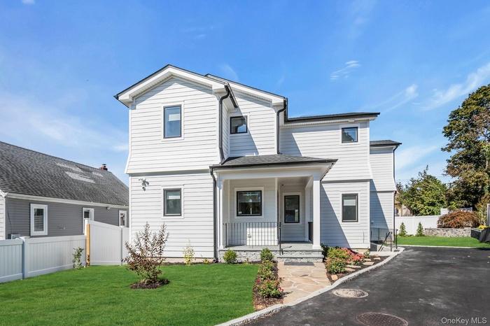 View of front of house with a porch and a shingled roof