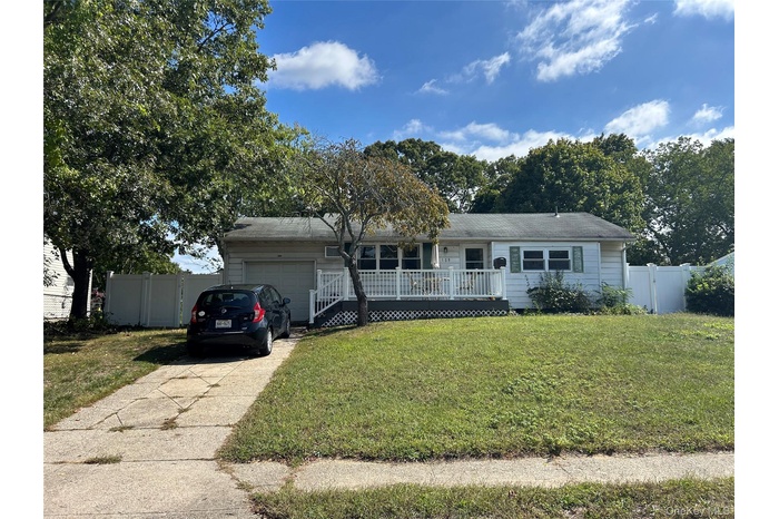 Ranch-style home featuring concrete driveway and a garage